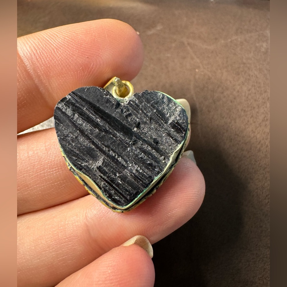 Vintage Black raw tourmaline in a heart set in a silver metal.